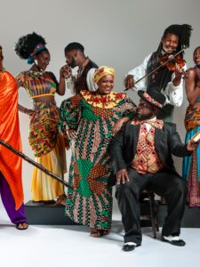 Group of people dressed in brightly colored costumes posing for the camera