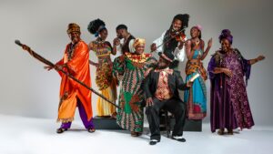 Group of people dressed in brightly colored costumes posing for the camera