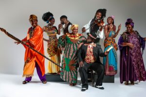 Group of people dressed in brightly colored costumes posing for the camera
