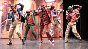 Group of men dancing in Guys and Dolls, 2023