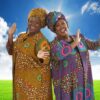 two women, cheek to cheek in brightly colored African looking costumes