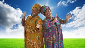 two women, cheek to cheek in brightly colored African looking costumes