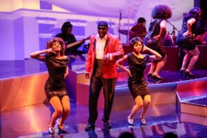 Dancers making "Call Me" motions