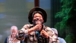 Man holding his beard and looking up