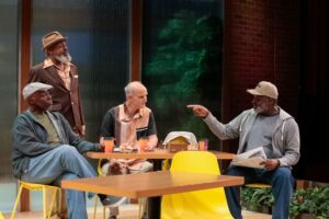 Group of men talking at restaurant.