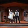 A Man and a woman on stage in old cabin