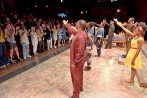 Audience members giving standing ovation