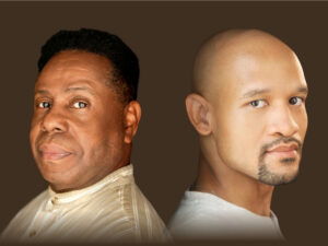 Two black men sitting back to back looking at the camera